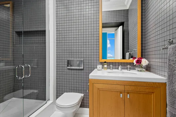 a utility room with granite countertop white cabinets and a sink