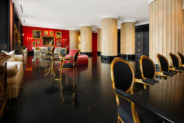 a room with lots of chairs and a large window