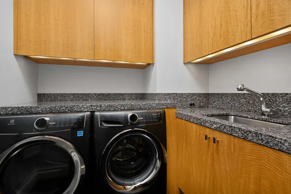 a living room with furniture fireplace and large windows