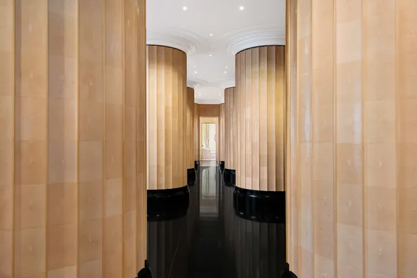 a spacious bedroom with a bed chandelier and a window