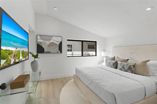 a bedroom with a large bed and a window