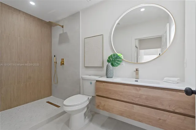 a bathroom with a sink a toilet and a mirror