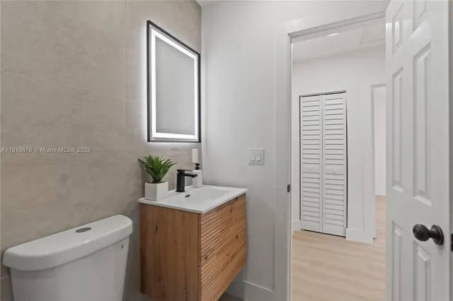 a bathroom with a toilet sink and mirror