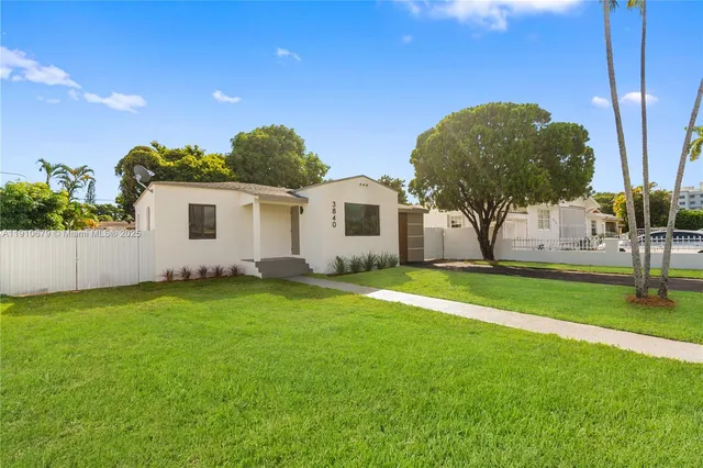 a view of a house with a backyard