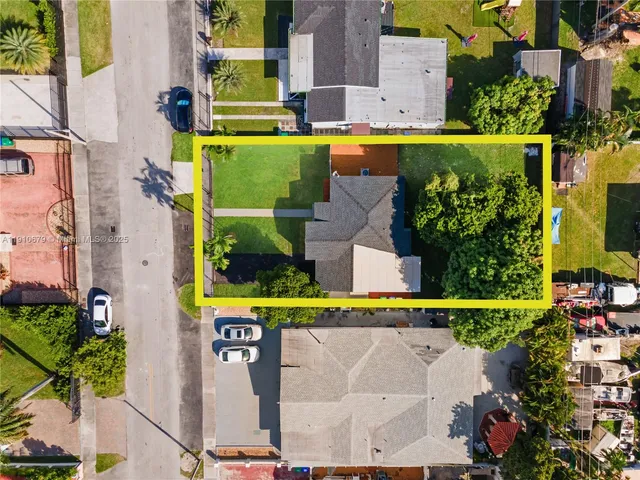 a view of swimming pool with a garden and plants