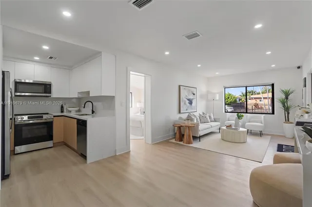 a kitchen with a refrigerator and a stove top oven