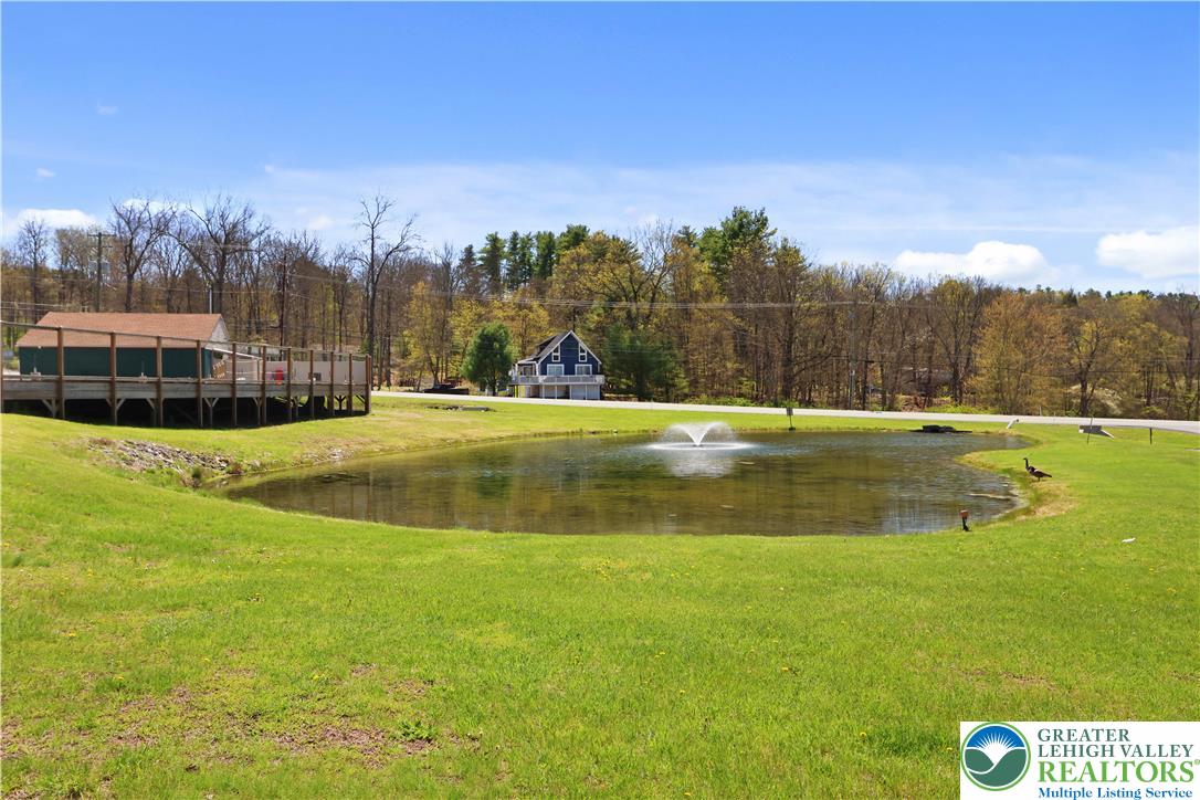 214 Mockingbird Court Bushkill, PA 18324 - Photo 30 of 40 a view of a swimming pool with an outdoor space and seating area