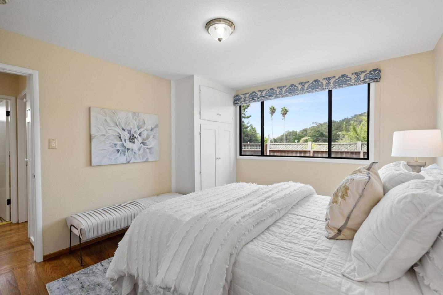 1127 Palou Drive Pacifica, CA 94044 - Photo 11 of 25 a bedroom with a bed and a large window