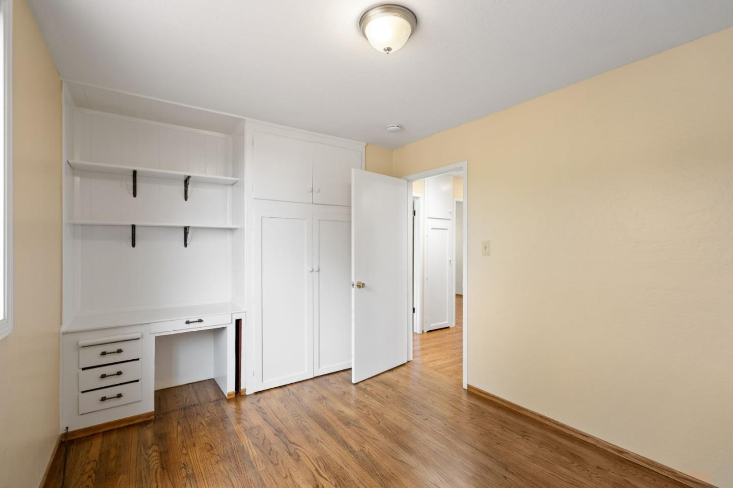 1127 Palou Drive Pacifica, CA 94044 - Photo 13 of 25 a view of an empty room with closet and wooden floor