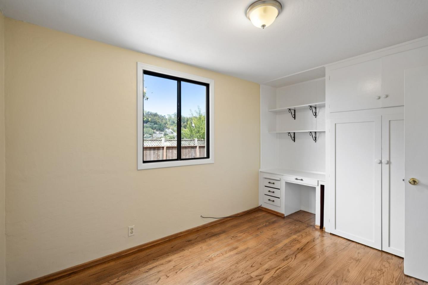 1127 Palou Drive Pacifica, CA 94044 - Photo 14 of 25 a view of empty room with wooden floor and window