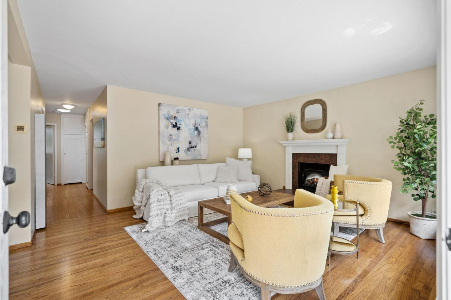1127 Palou Drive Pacifica, CA 94044 - Photo 6 of 25 a living room with furniture a fireplace and a potted plant