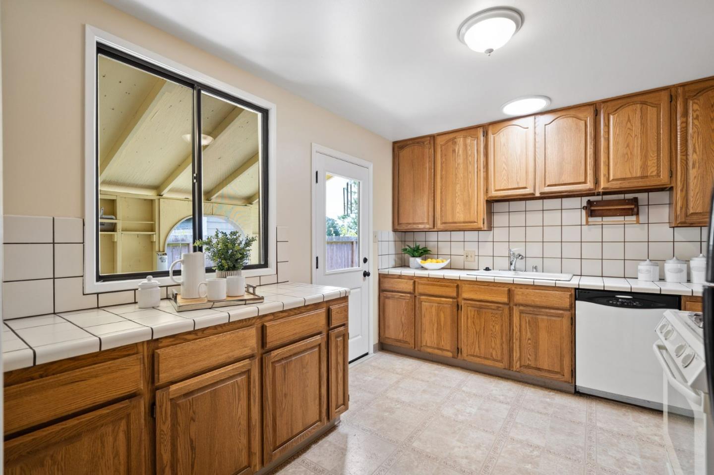 1127 Palou Drive Pacifica, CA 94044 - Photo 9 of 25 a bathroom with a granite countertop sink mirror and a bathtub