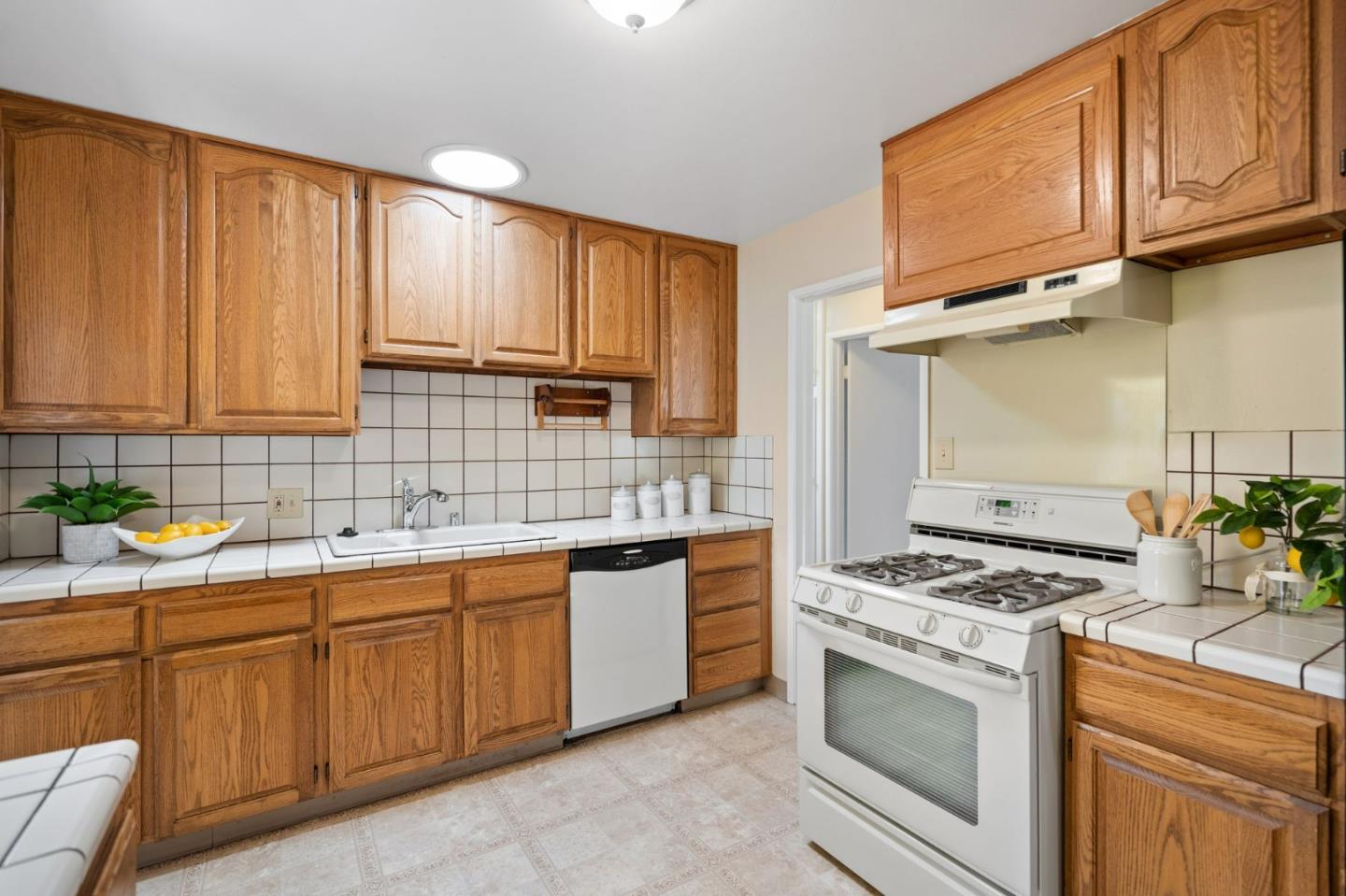 1127 Palou Drive Pacifica, CA 94044 - Photo 10 of 25 a kitchen with stainless steel appliances granite countertop a sink stove and cabinets
