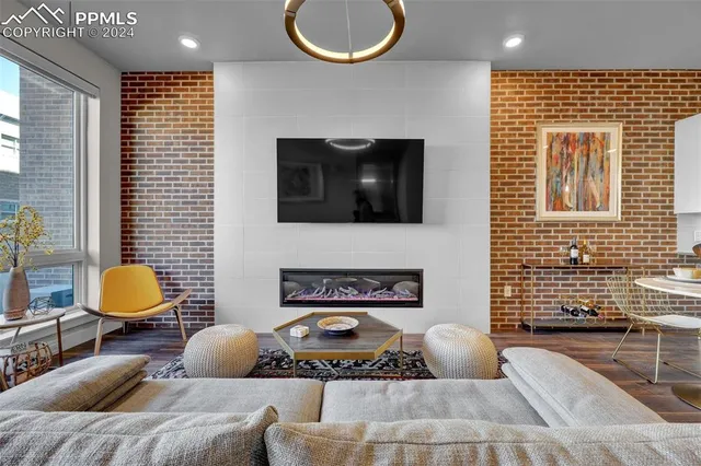 a living room with furniture a rug and a flat screen tv