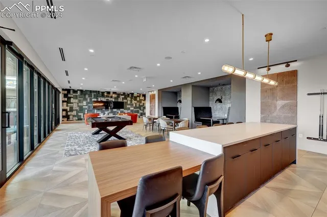 a large kitchen with a large counter top furniture and stainless steel appliances