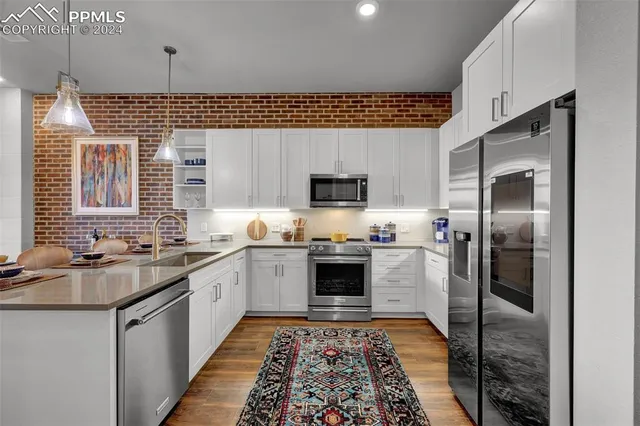 a kitchen with a sink stove and refrigerator