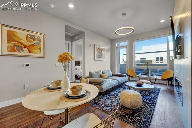 a living room with furniture and wooden floor