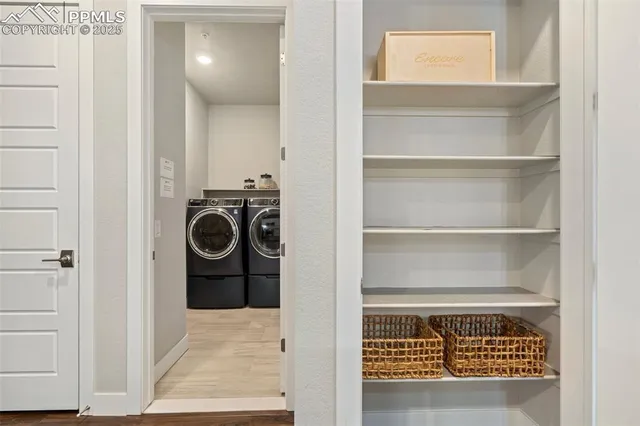 a view of a hallway with washer and dryer