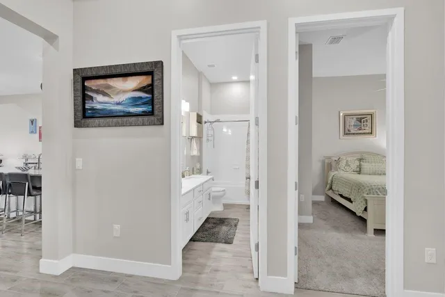 a bathroom with a sink toilet vanity and shower