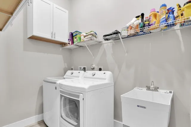 a kitchen with stainless steel appliances a stove a sink a microwave a refrigerator and cabinets