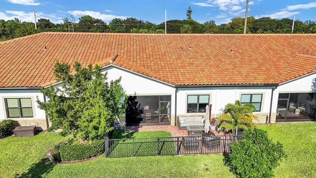 a aerial view of a house with a garden and lake view