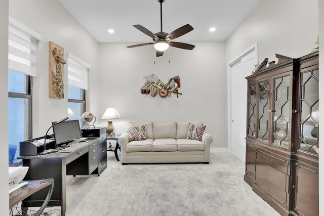 a view of a workspace with furniture and a window