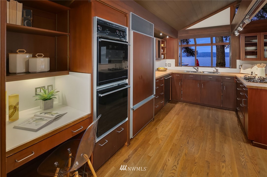 6669 Northeast Windermere Road Seattle, WA 98115 - Photo 11 of 36 a kitchen with stainless steel appliances a stove a sink and a refrigerator