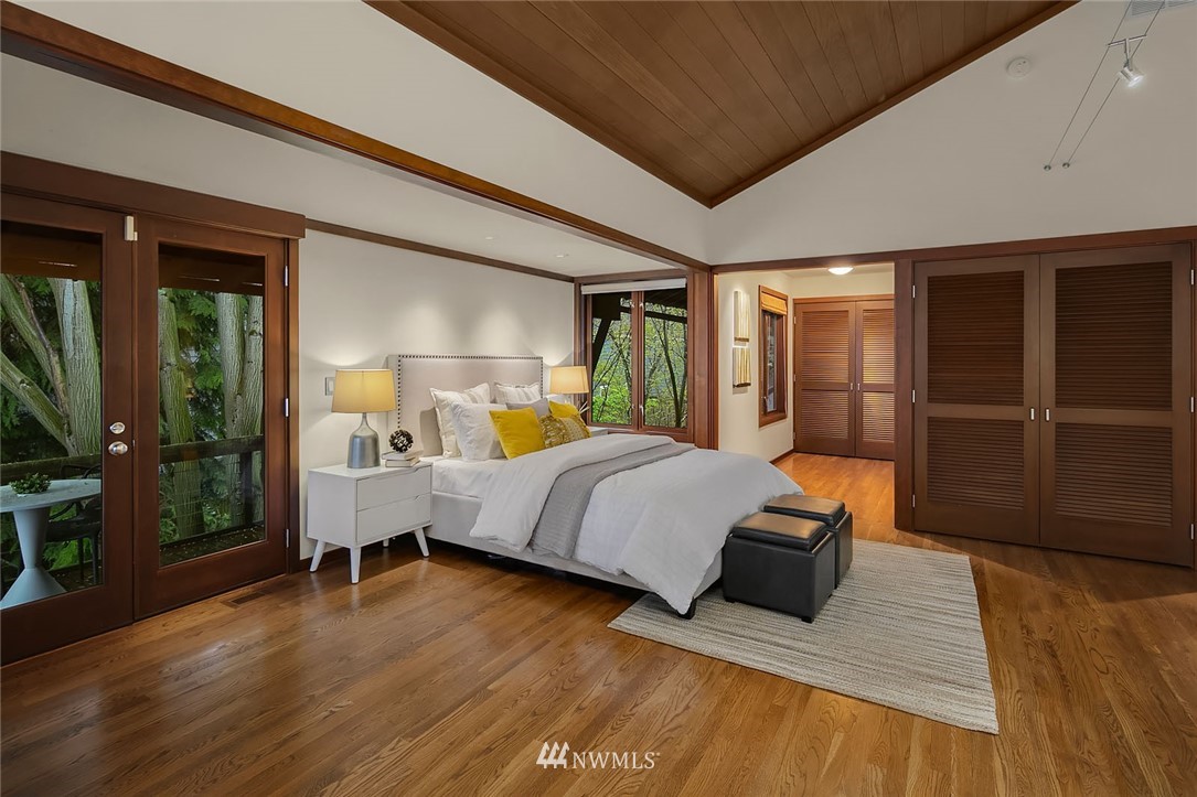 6669 Northeast Windermere Road Seattle, WA 98115 - Photo 16 of 36 a bedroom with a bed and wooden floor