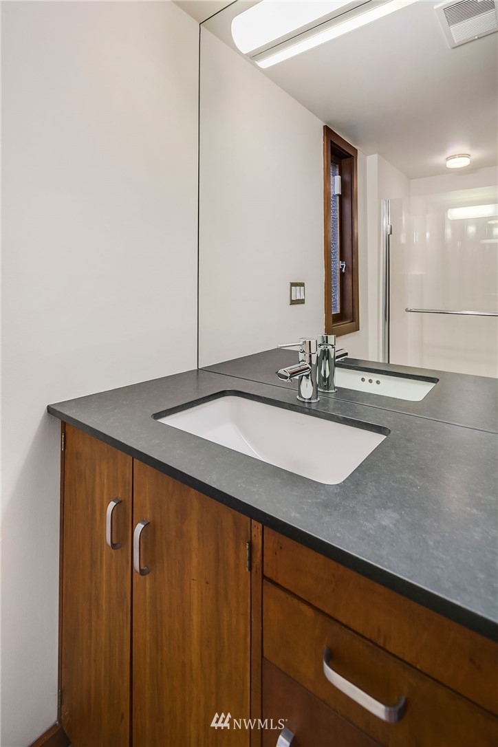 6669 Northeast Windermere Road Seattle, WA 98115 - Photo 23 of 36 a bathroom with a sink and a mirror