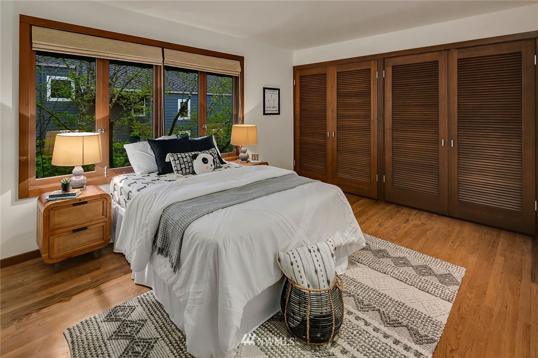 6669 Northeast Windermere Road Seattle, WA 98115 - Photo 24 of 36 a bedroom with a bed and wooden floor