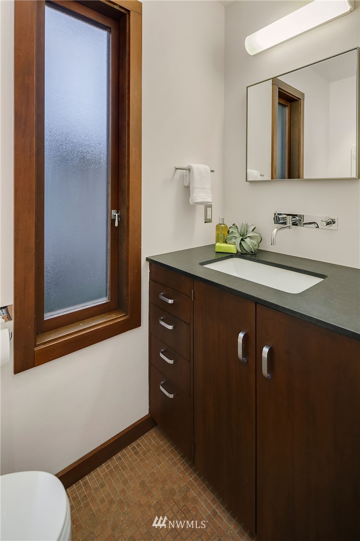 6669 Northeast Windermere Road Seattle, WA 98115 - Photo 25 of 36 a bathroom with a sink vanity and a mirror