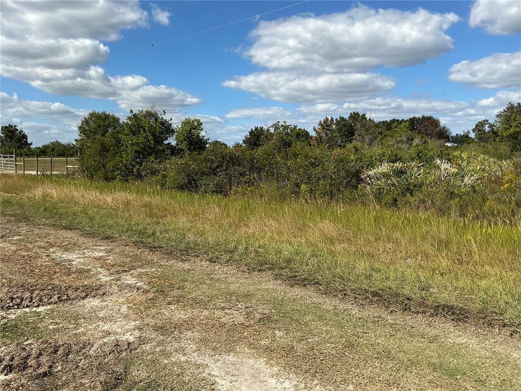 15939 Northwest 264th Street Okeechobee, FL 34972 - Photo 2 of 4 a view of a lake with houses in the back