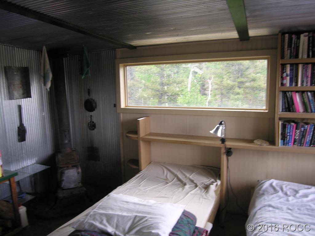 880 Burno Mountain Road Cotopaxi, CO 81223 - Photo 11 of 19 a bedroom with a bed and a book shelf