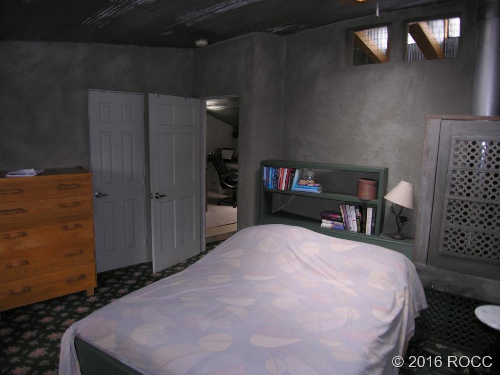 880 Burno Mountain Road Cotopaxi, CO 81223 - Photo 7 of 19 a bedroom with a bed and a cabinets