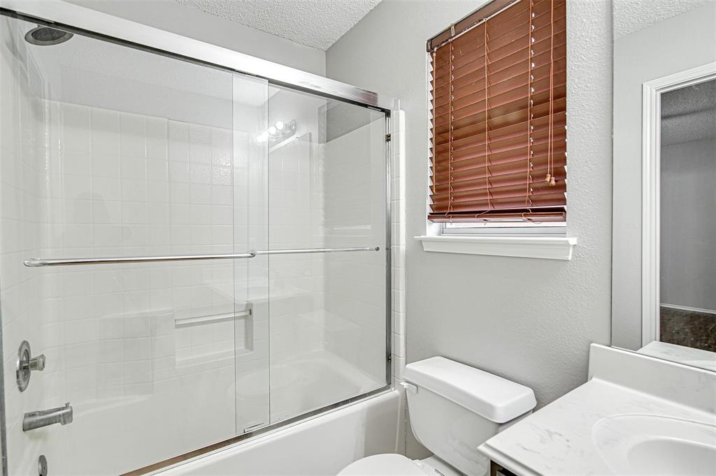 636 Green Mountain Road Burleson, TX 76028 - Photo 12 of 19 a white toilet sitting next to a shower