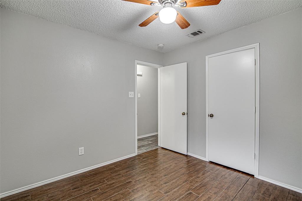 636 Green Mountain Road Burleson, TX 76028 - Photo 14 of 19 a view of an empty room with wooden floor and a ceiling fan