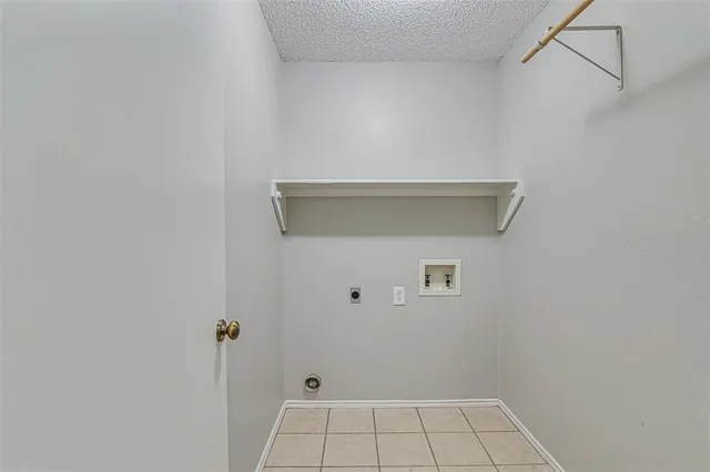 an empty room with wooden floor chandelier fan and closet area