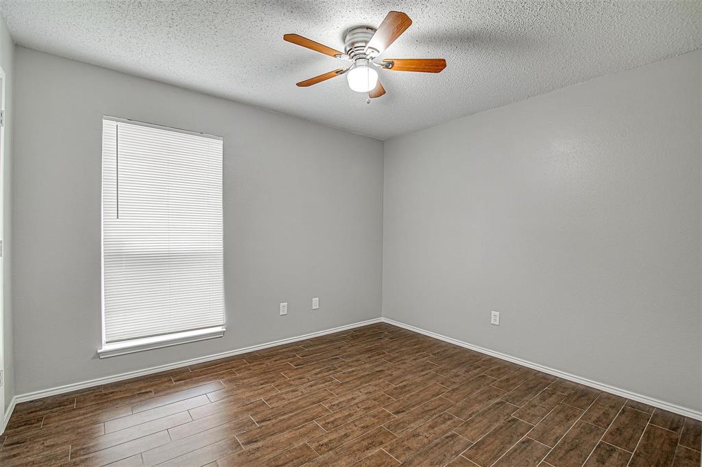 636 Green Mountain Road Burleson, TX 76028 - Photo 17 of 19 a view of empty room with wooden floor and fan
