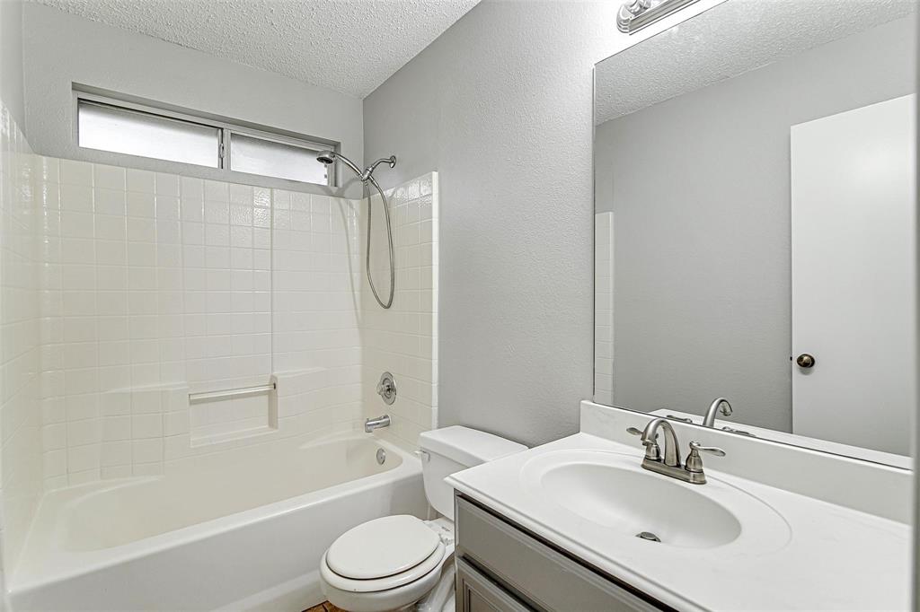 636 Green Mountain Road Burleson, TX 76028 - Photo 18 of 19 a bathroom with a sink toilet and shower