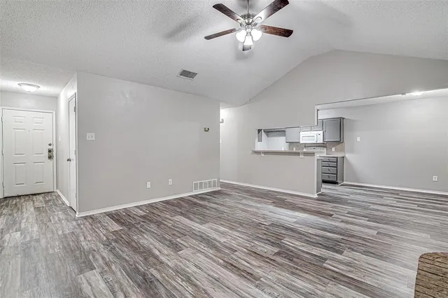 a view of a kitchen with a dishwasher and wooden floor