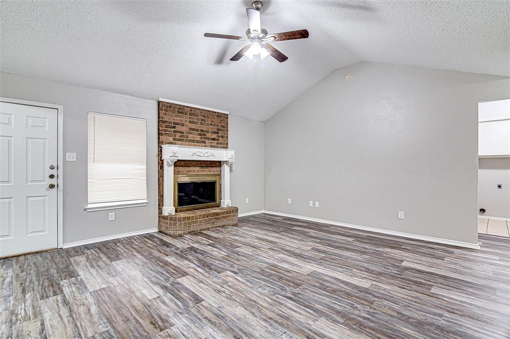 636 Green Mountain Road Burleson, TX 76028 - Photo 4 of 19 a view of empty room with fireplace and fan