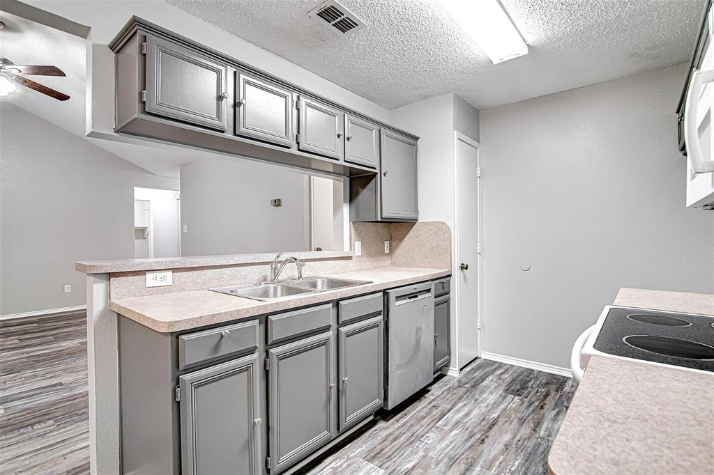 636 Green Mountain Road Burleson, TX 76028 - Photo 6 of 19 a kitchen with a sink and a refrigerator
