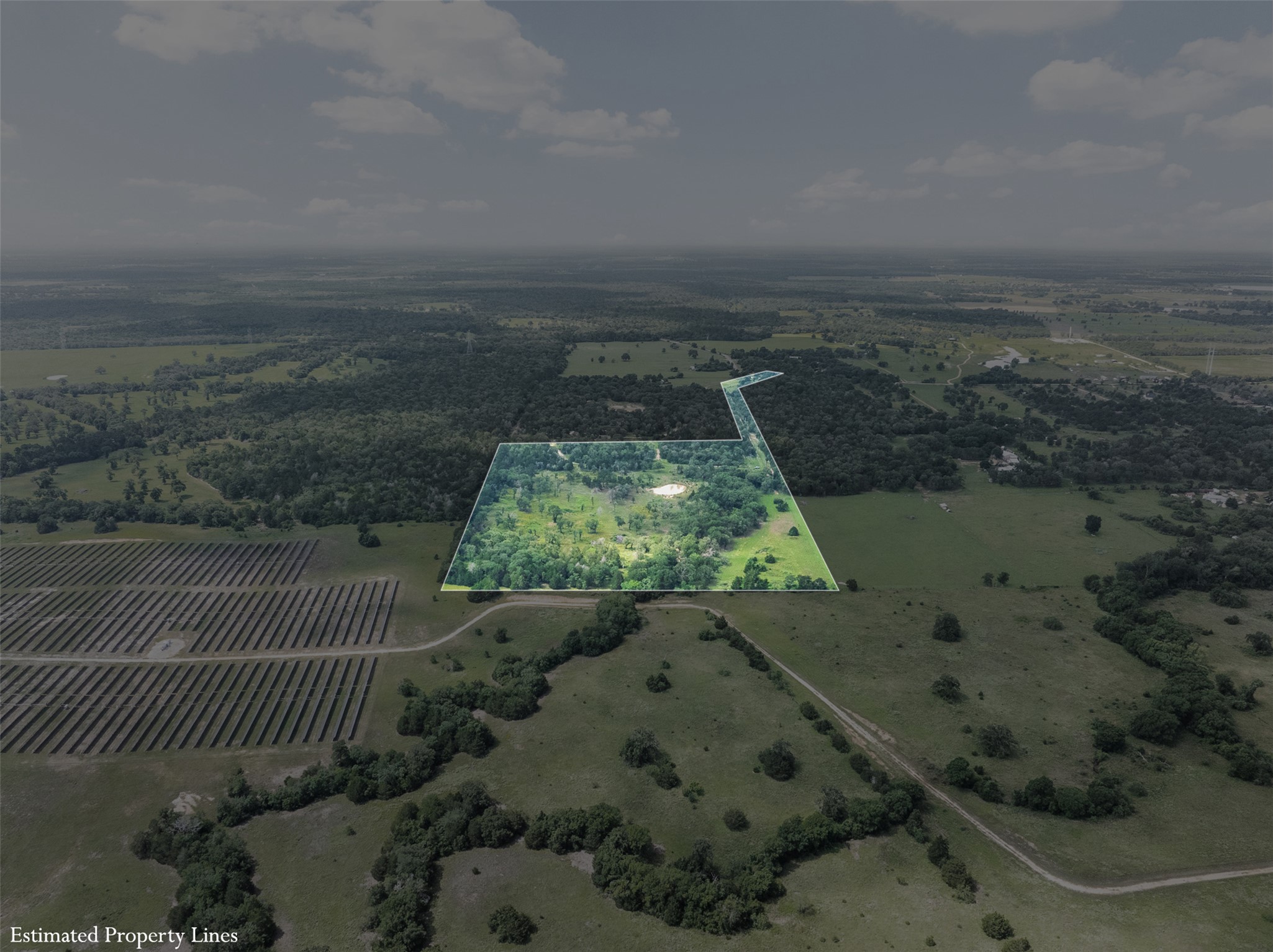 305 Cistern Road Rosanky, TX 78953 - Photo 13 of 13 A sweeping aerial view showcases a verdant lot amidst mature trees and open fields.