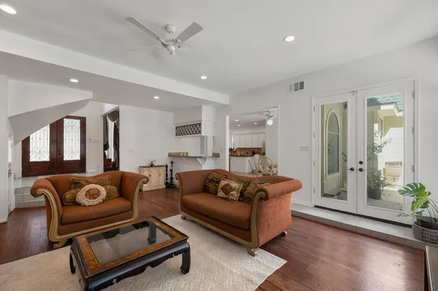 a living room with furniture and wooden floor