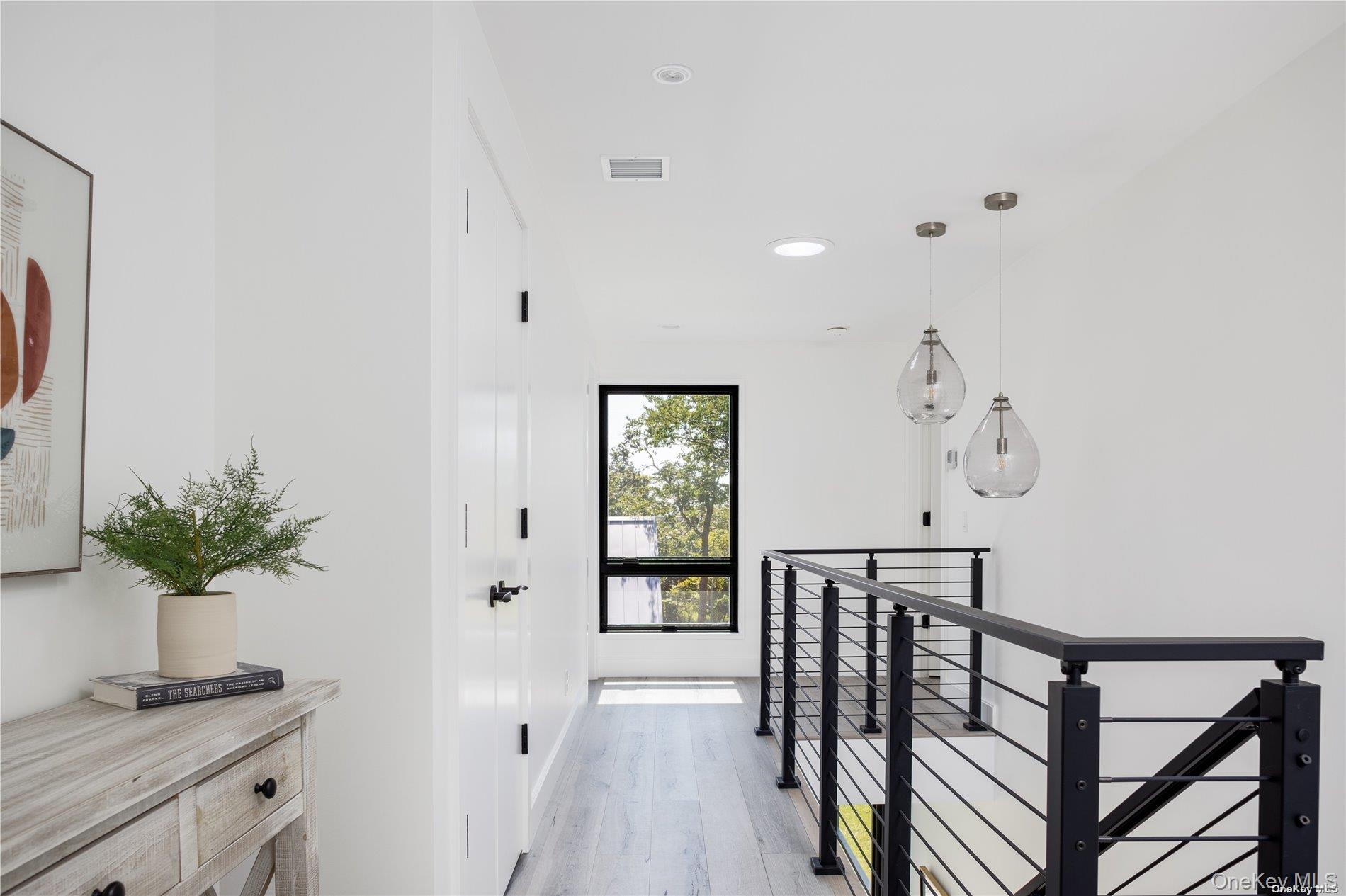 290 Windward Road Orient, NY 11957 - Photo 18 of 31 a view of a hallway with wooden floor and a potted plant