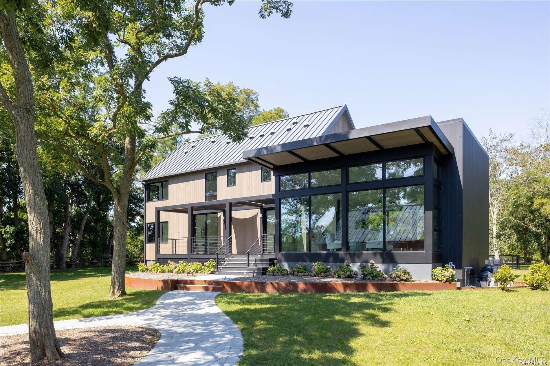 290 Windward Road Orient, NY 11957 - Photo 4 of 31 a front view of a house with a yard table and chairs