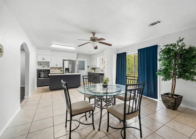 a view of a dining room with furniture and window