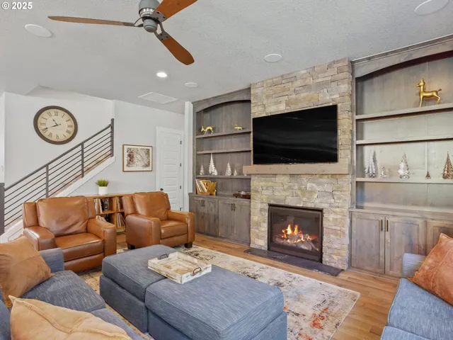 a living room with furniture a fireplace and a flat screen tv
