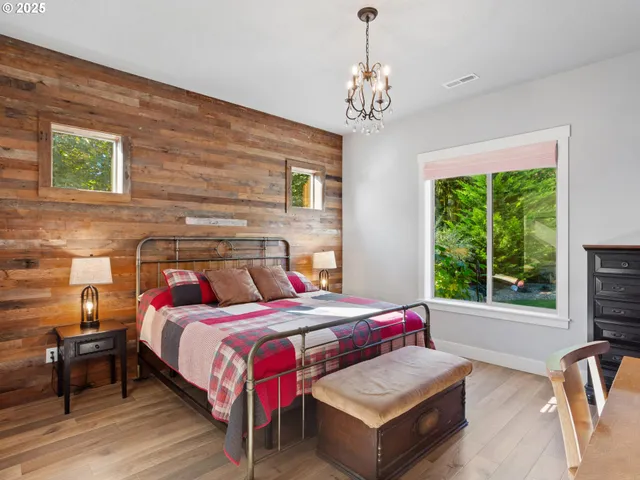 a bedroom with a bed couch and window