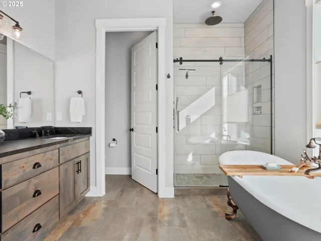 a bathroom with a granite countertop sink a toilet and shower